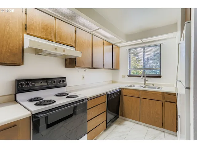 a kitchen with a refrigerator and a sink