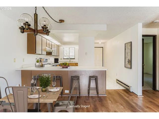 a view of kitchen with refrigerator and window