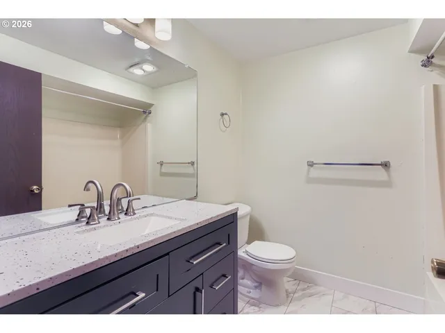 a bathroom with a sink vanity and a mirror