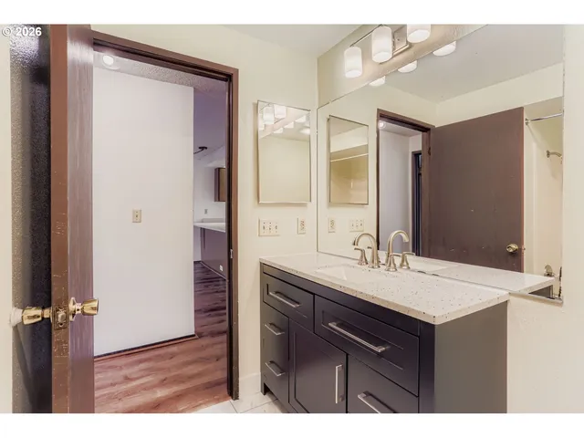 a bedroom with a large bed and a potted plant