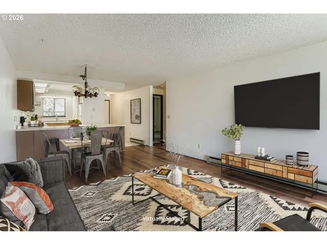 a view of a room with a ceiling fan and hardwood floor