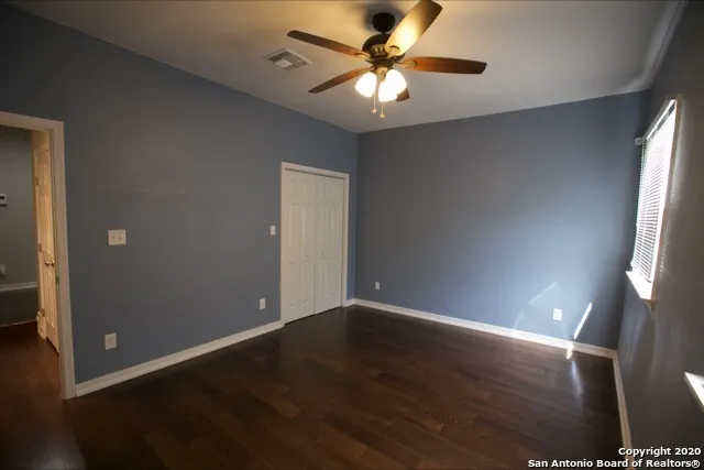 an empty room with wooden floor