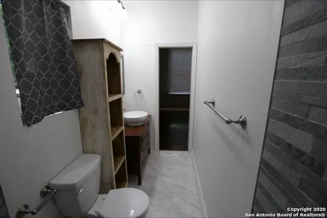a bathroom with a sink a toilet and bathtub