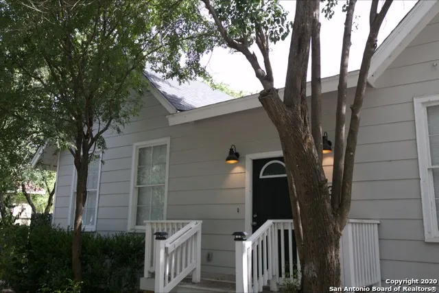 a view of a hallway with wooden floor and a chandelier