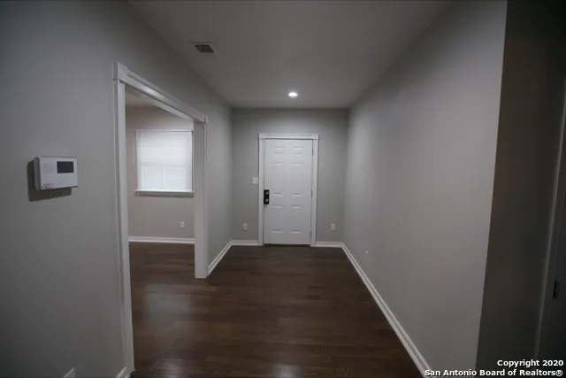 a kitchen with a refrigerator and cabinets