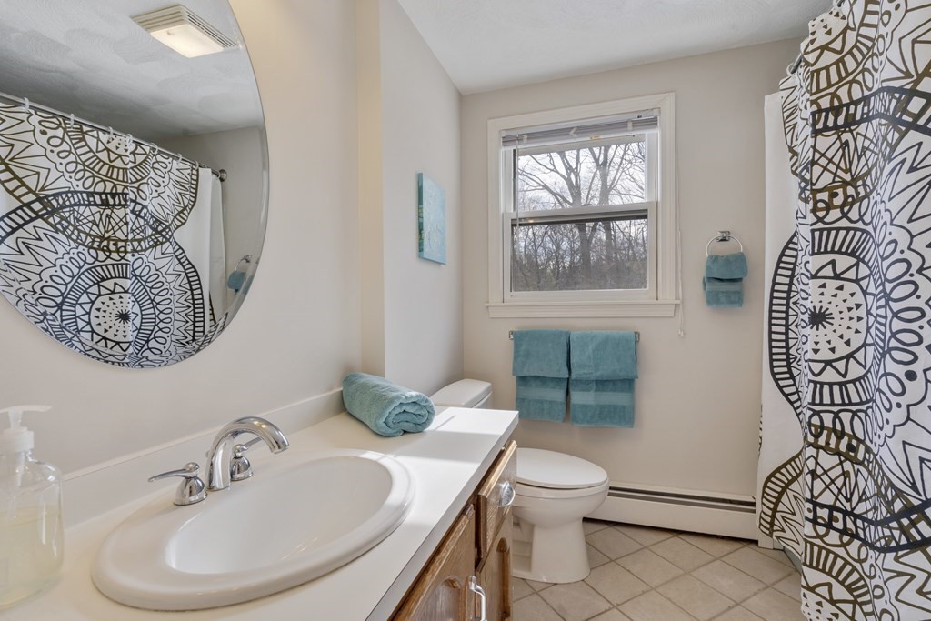 430 River Road Andover, MA 01810 - Photo 15 of 25 a bathroom with a sink a toilet and mirror