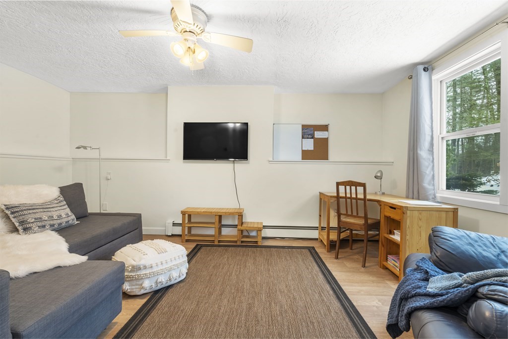 430 River Road Andover, MA 01810 - Photo 16 of 25 a living room with furniture and a flat screen tv