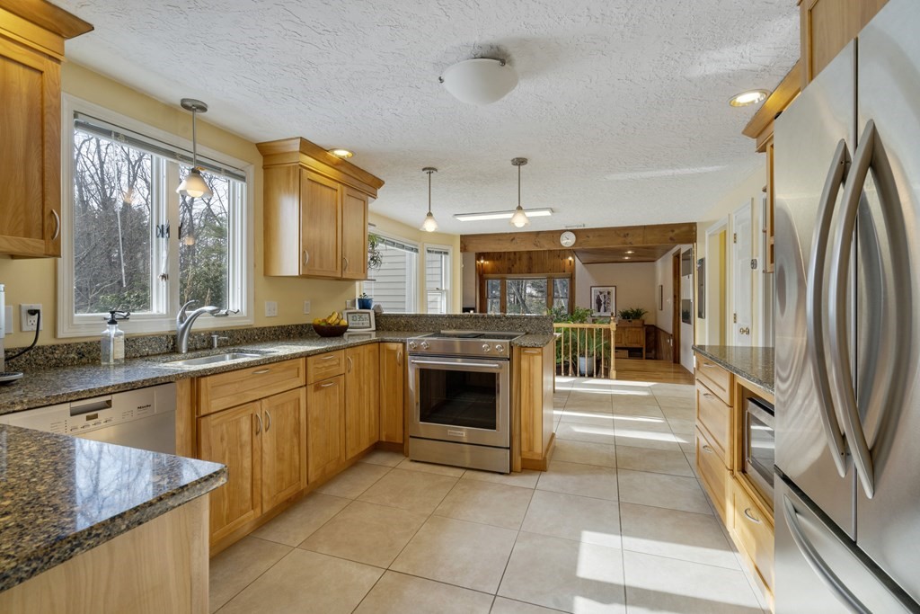 430 River Road Andover, MA 01810 - Photo 6 of 25 a large kitchen with stainless steel appliances granite countertop a refrigerator a oven and a sink with granite countertops