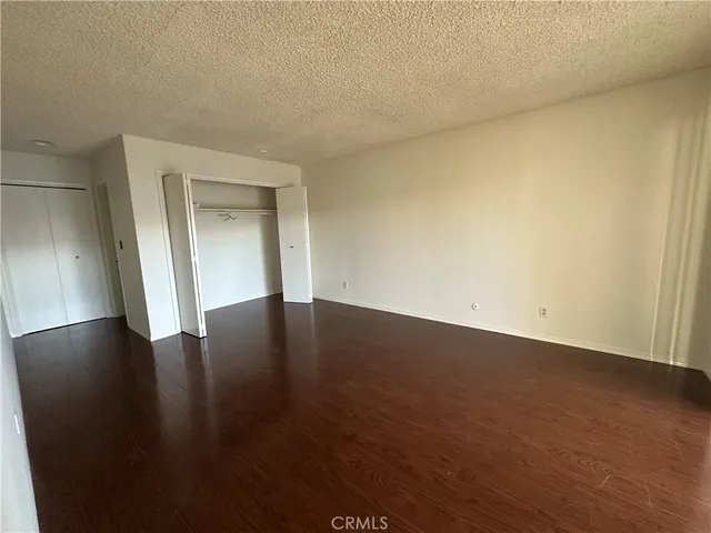a view of a livingroom with wooden floor and a window