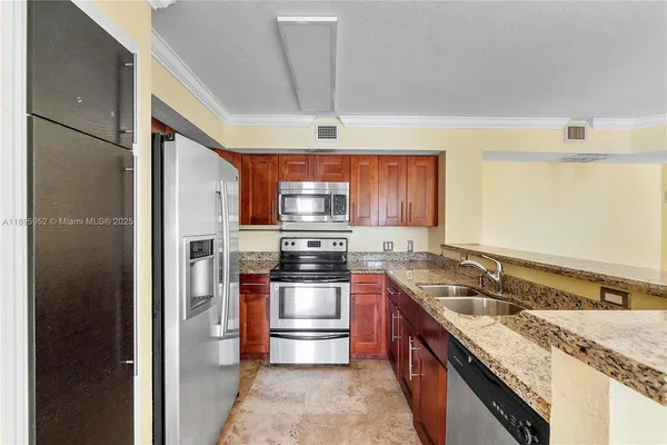 a kitchen with stainless steel appliances granite countertop a sink stove and refrigerator