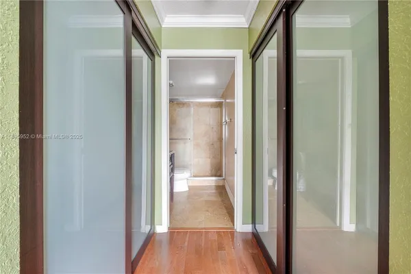 a view of a hallway with wooden floor