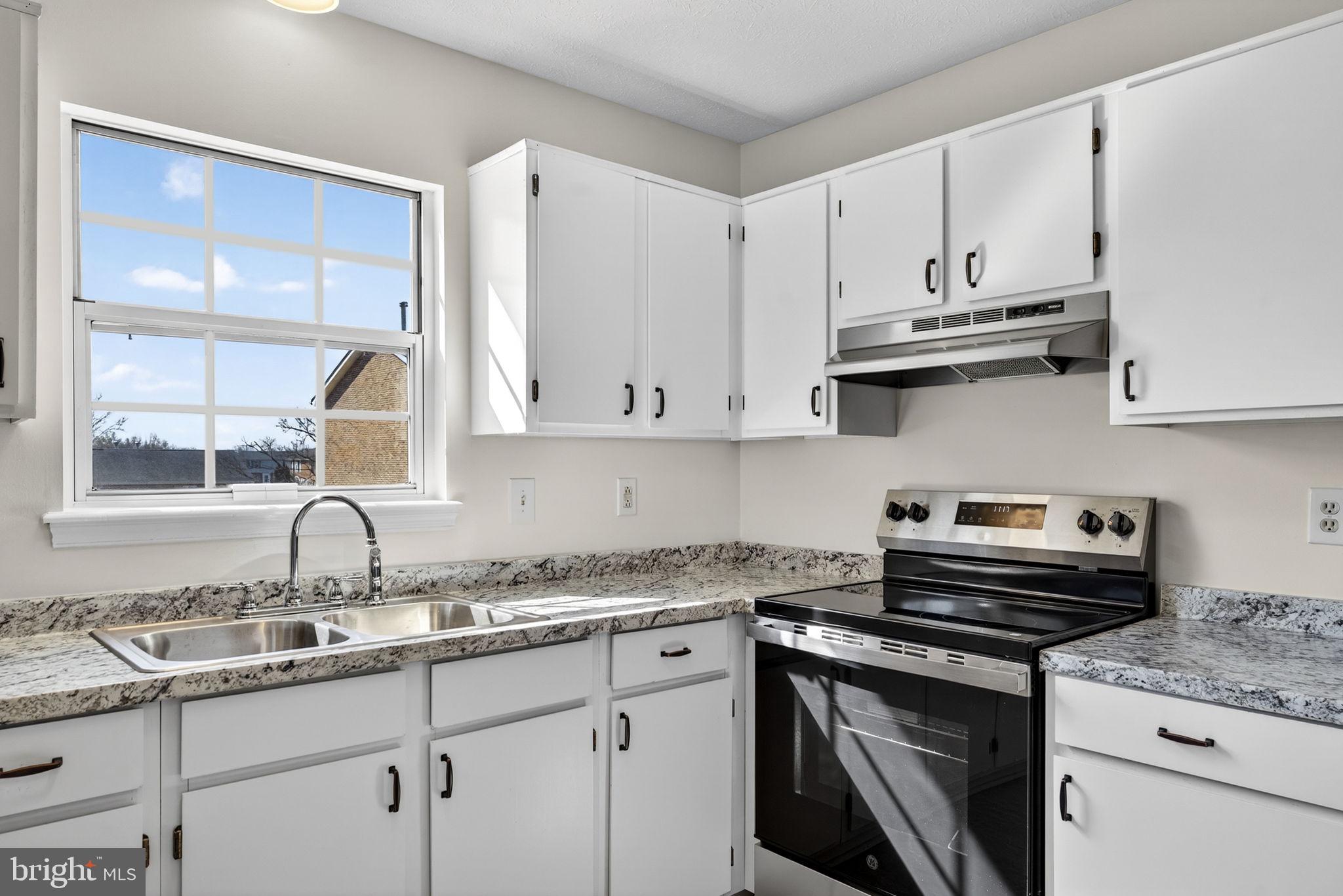 352 Valley Mill Road Winchester, VA 22602 - Photo 11 of 28 a kitchen with granite countertop a sink a stove and cabinets