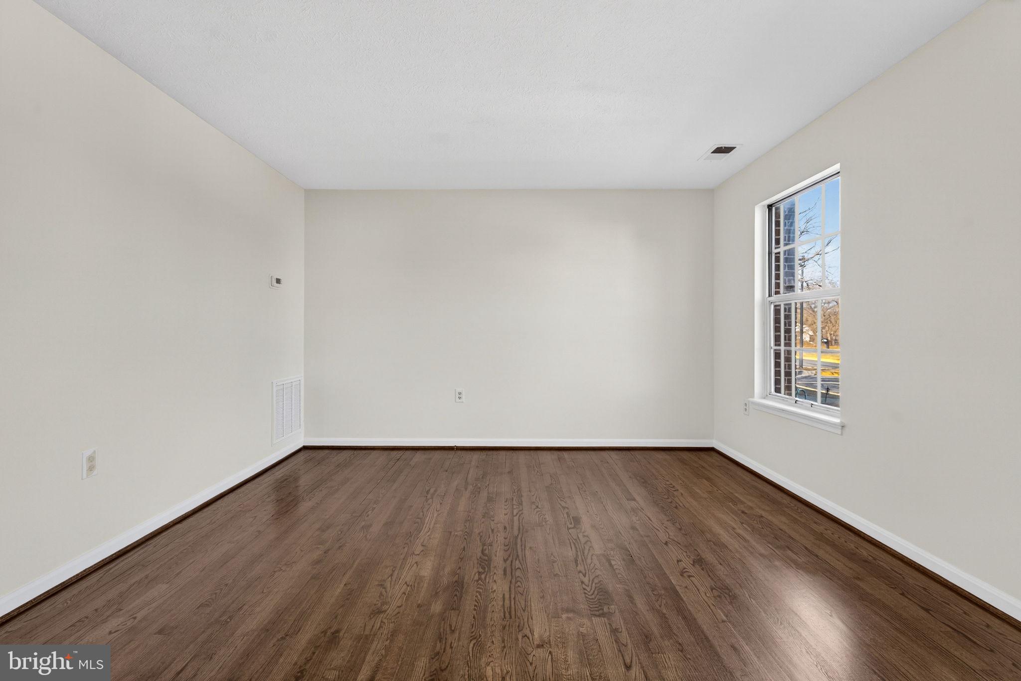 352 Valley Mill Road Winchester, VA 22602 - Photo 6 of 28 a view of an empty room with wooden floor and a window