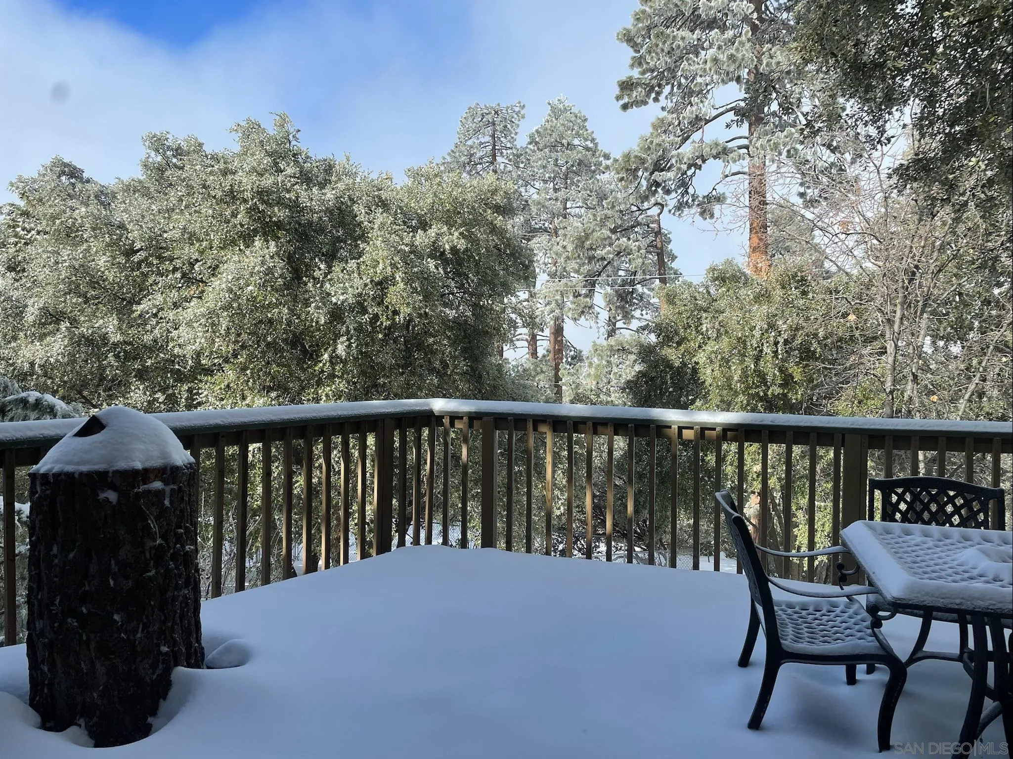 24735 Marion Ridge Drive Idyllwild, CA 92549 - Photo 16 of 29 a balcony with wooden floor and bench