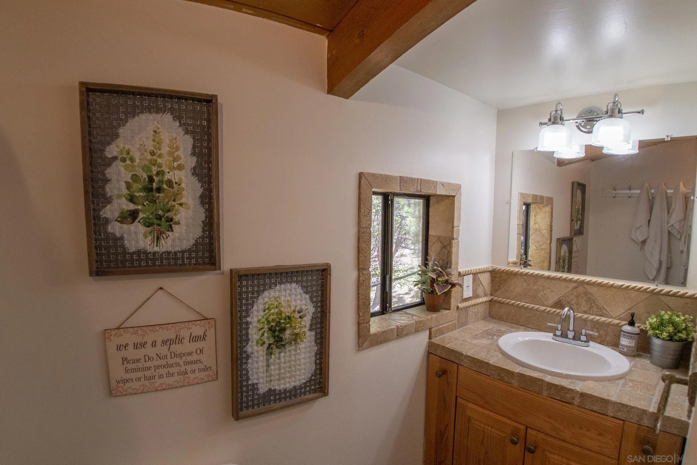 24735 Marion Ridge Drive Idyllwild, CA 92549 - Photo 23 of 29 a bathroom with a sink and a mirror