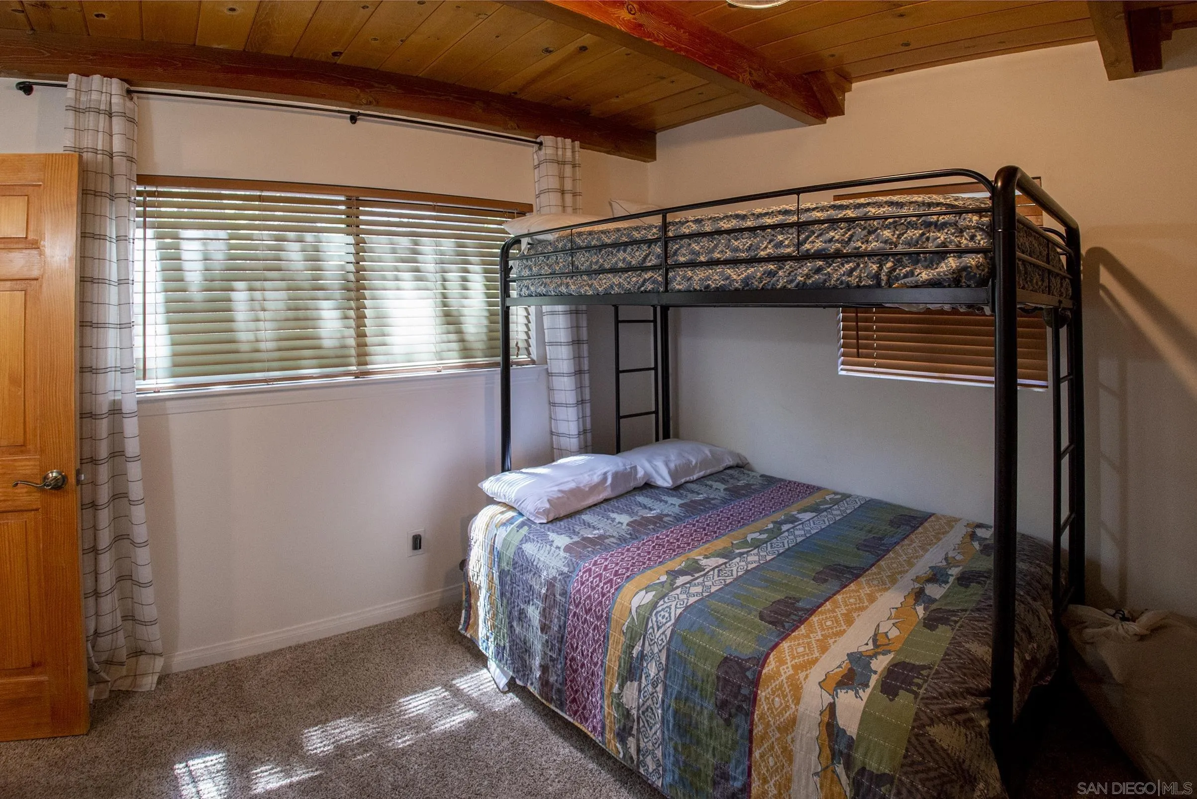 24735 Marion Ridge Drive Idyllwild, CA 92549 - Photo 25 of 29 a bed sitting in a bedroom next to a window