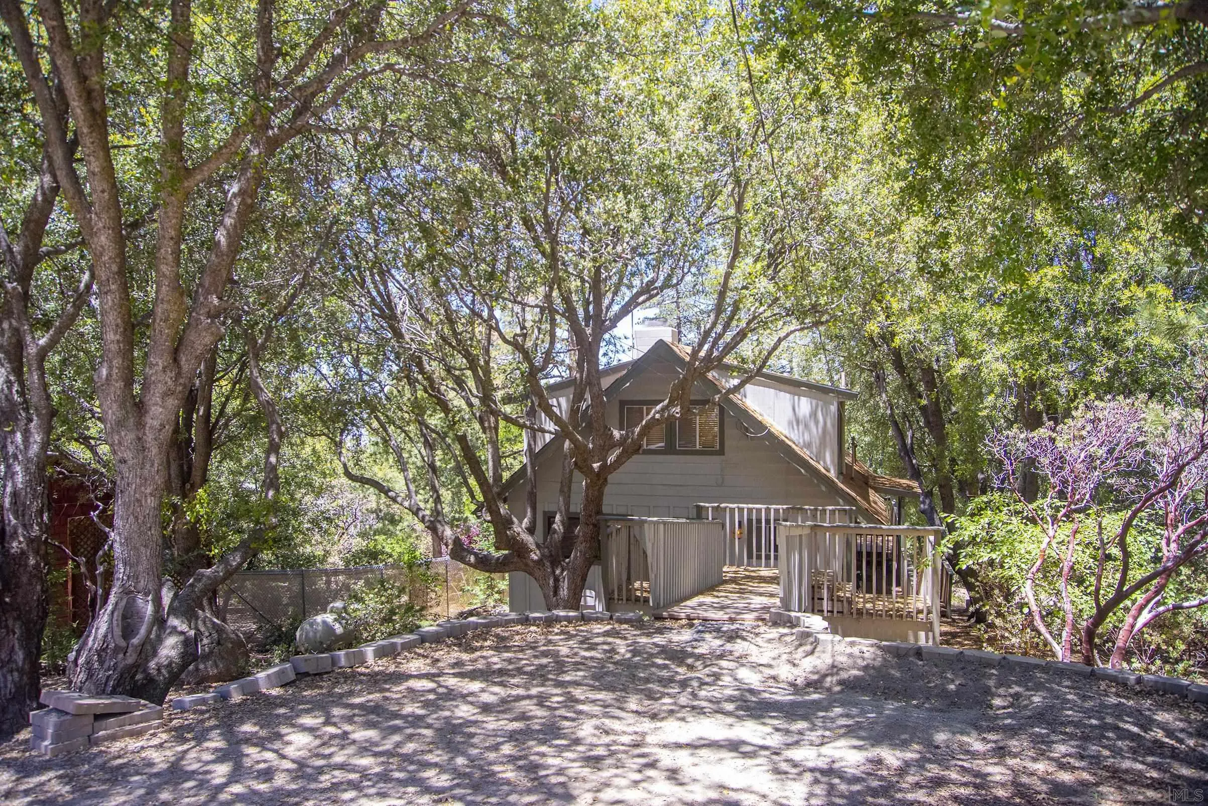 24735 Marion Ridge Drive Idyllwild, CA 92549 - Photo 29 of 29 a front view of a house with a yard and large tree