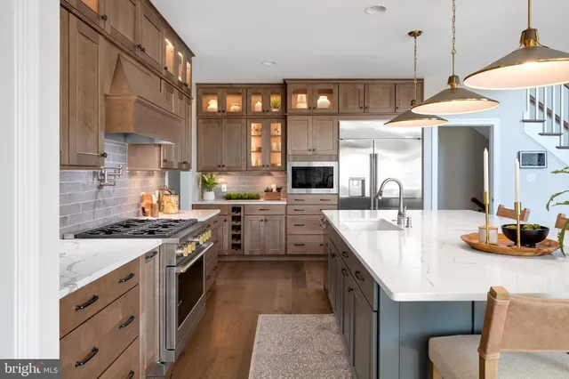 a kitchen with stainless steel appliances white cabinets and a sink