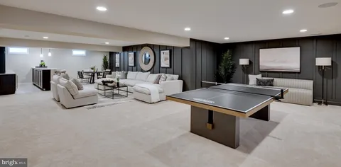 a living room with furniture and a book shelf