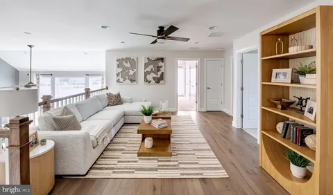 a dining room with furniture a chandelier and wooden floor