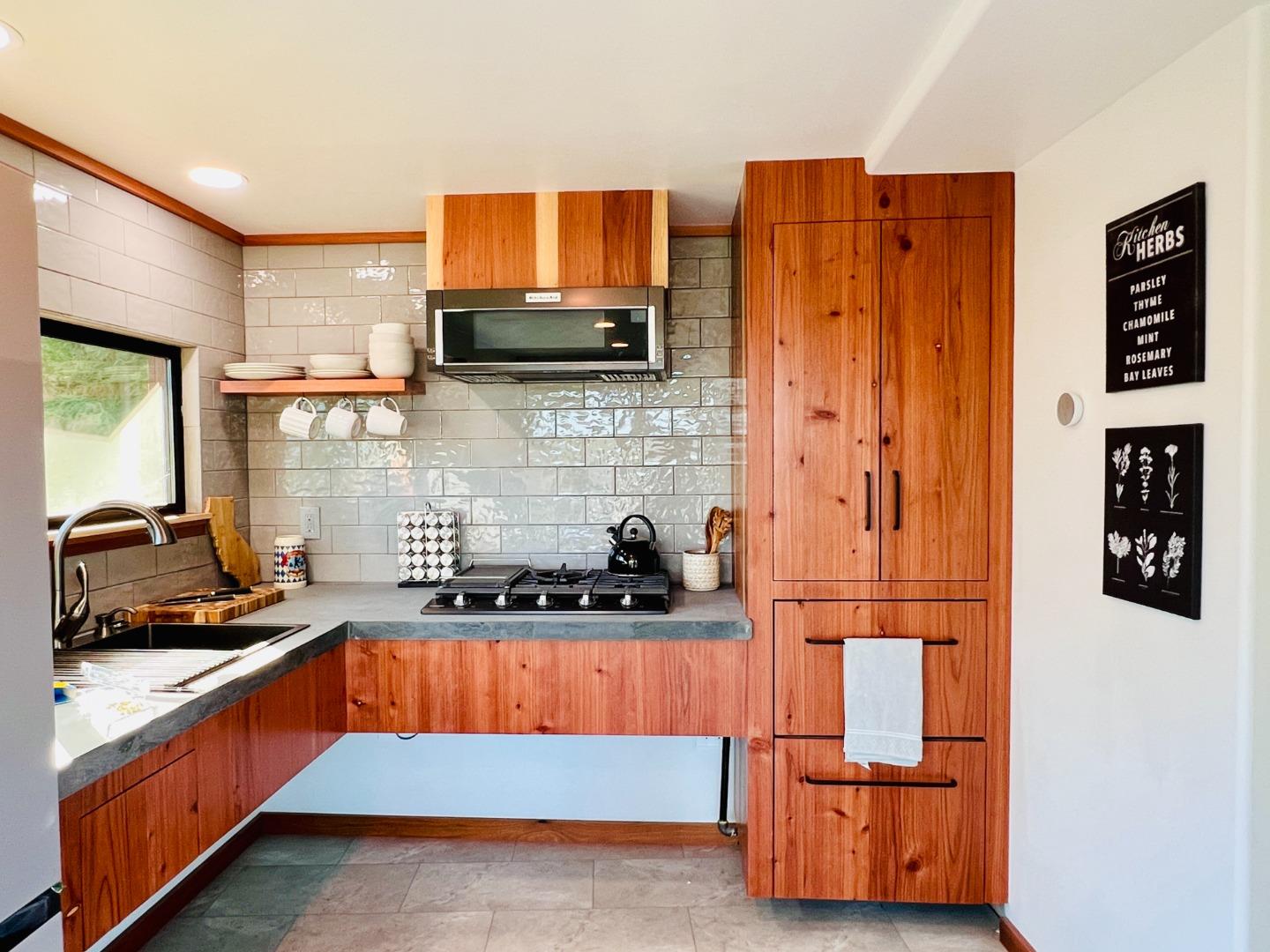 518 Container Way Boulder Creek, CA 95006 - Photo 16 of 33 a kitchen with stainless steel appliances granite countertop a stove a sink and a refrigerator