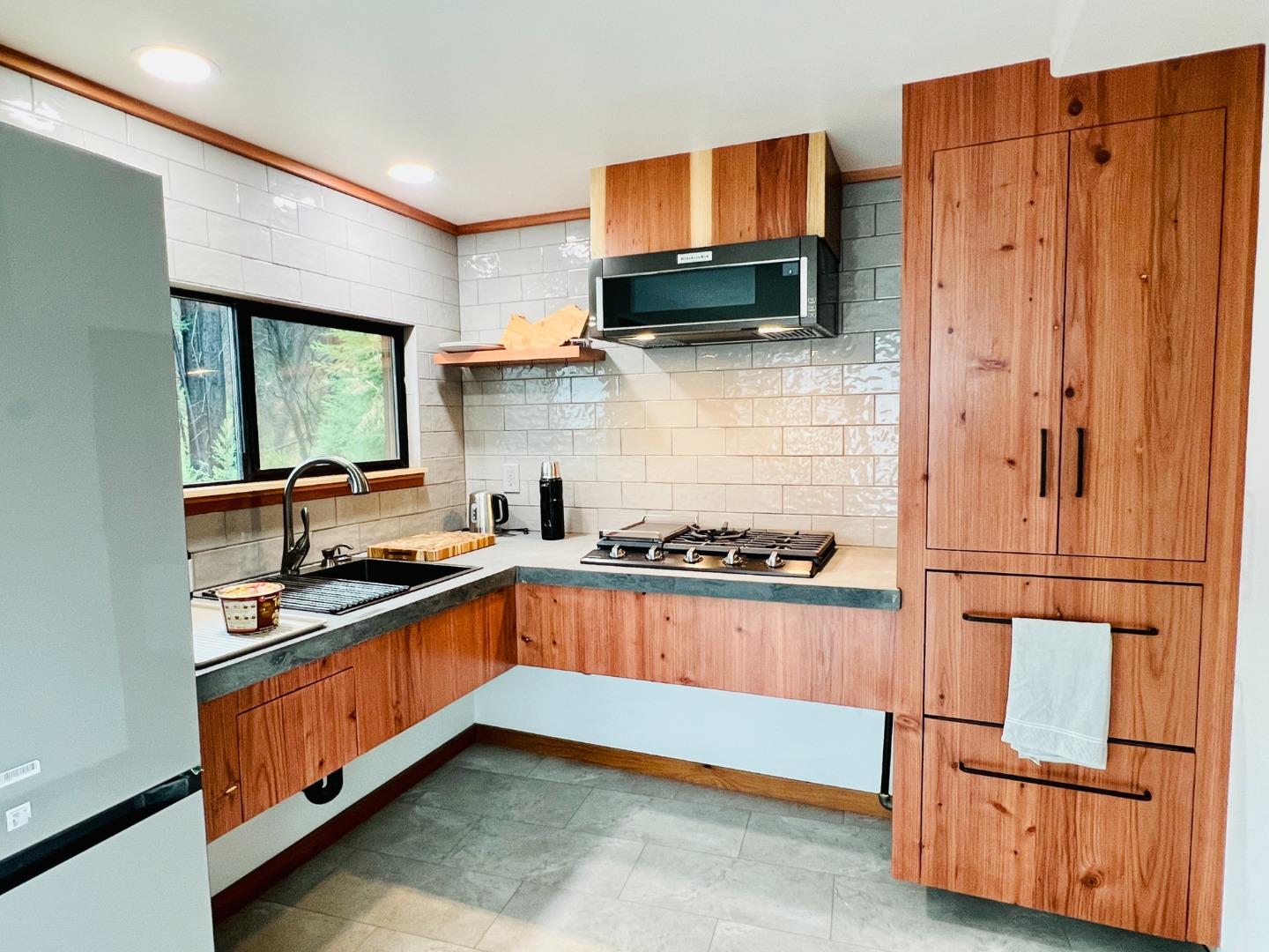 518 Container Way Boulder Creek, CA 95006 - Photo 4 of 33 a kitchen with stainless steel appliances granite countertop a stove a sink and a refrigerator