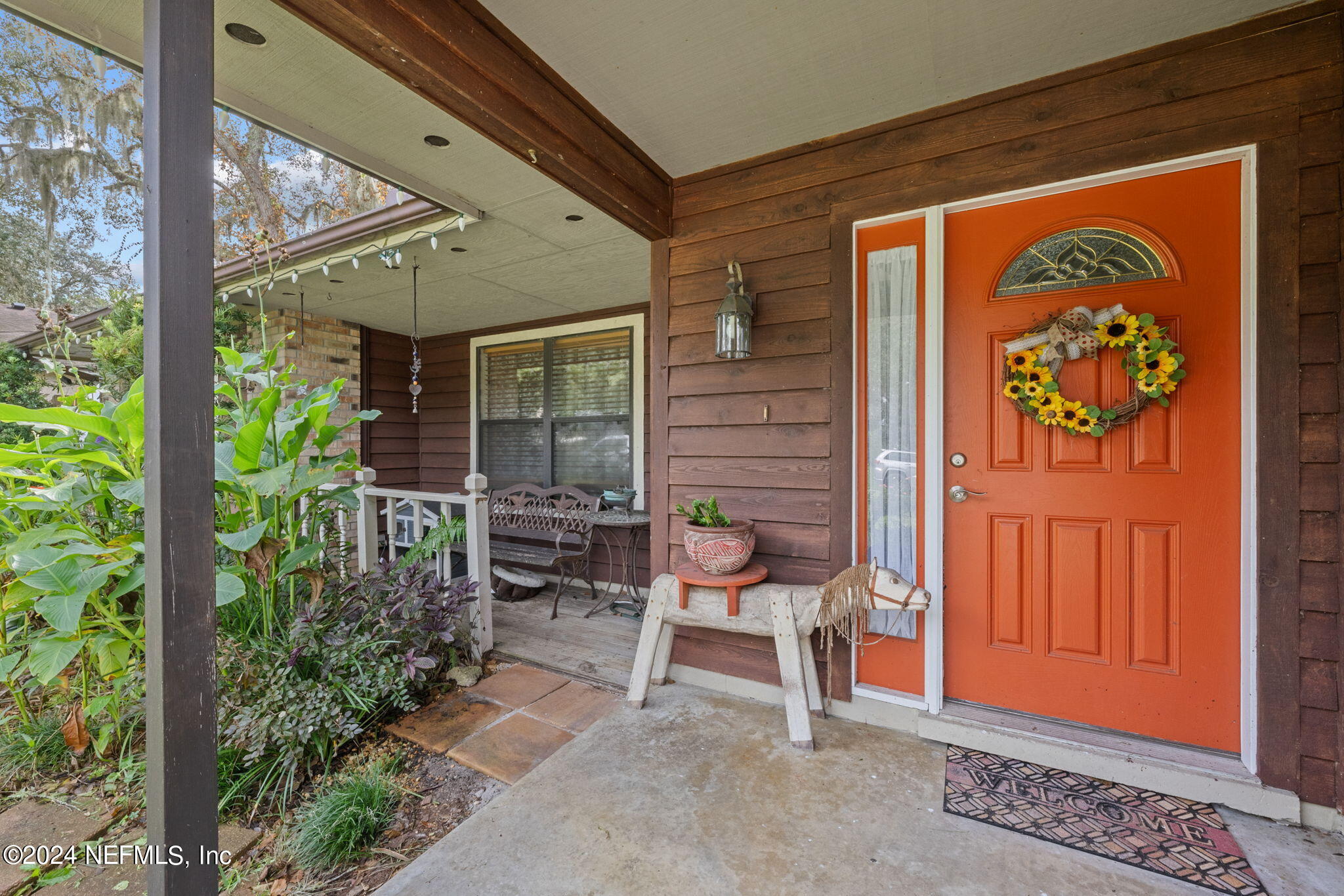 529 Fox Hollow Lane St. Augustine, FL 32086 - Photo 3 of 18 a view of porch with a bench and floor to ceiling window