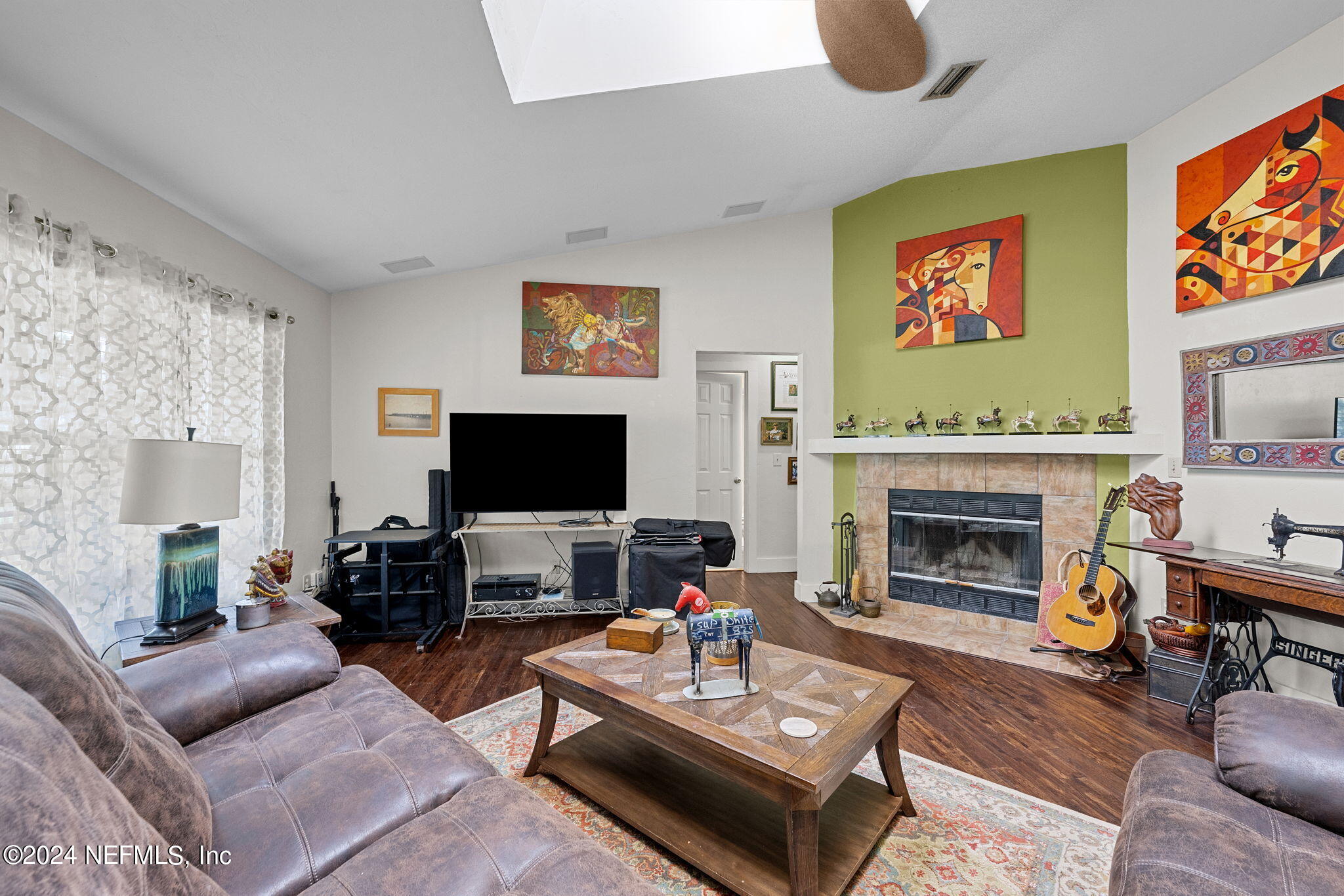 529 Fox Hollow Lane St. Augustine, FL 32086 - Photo 4 of 18 a living room with furniture a flat screen tv and a fireplace
