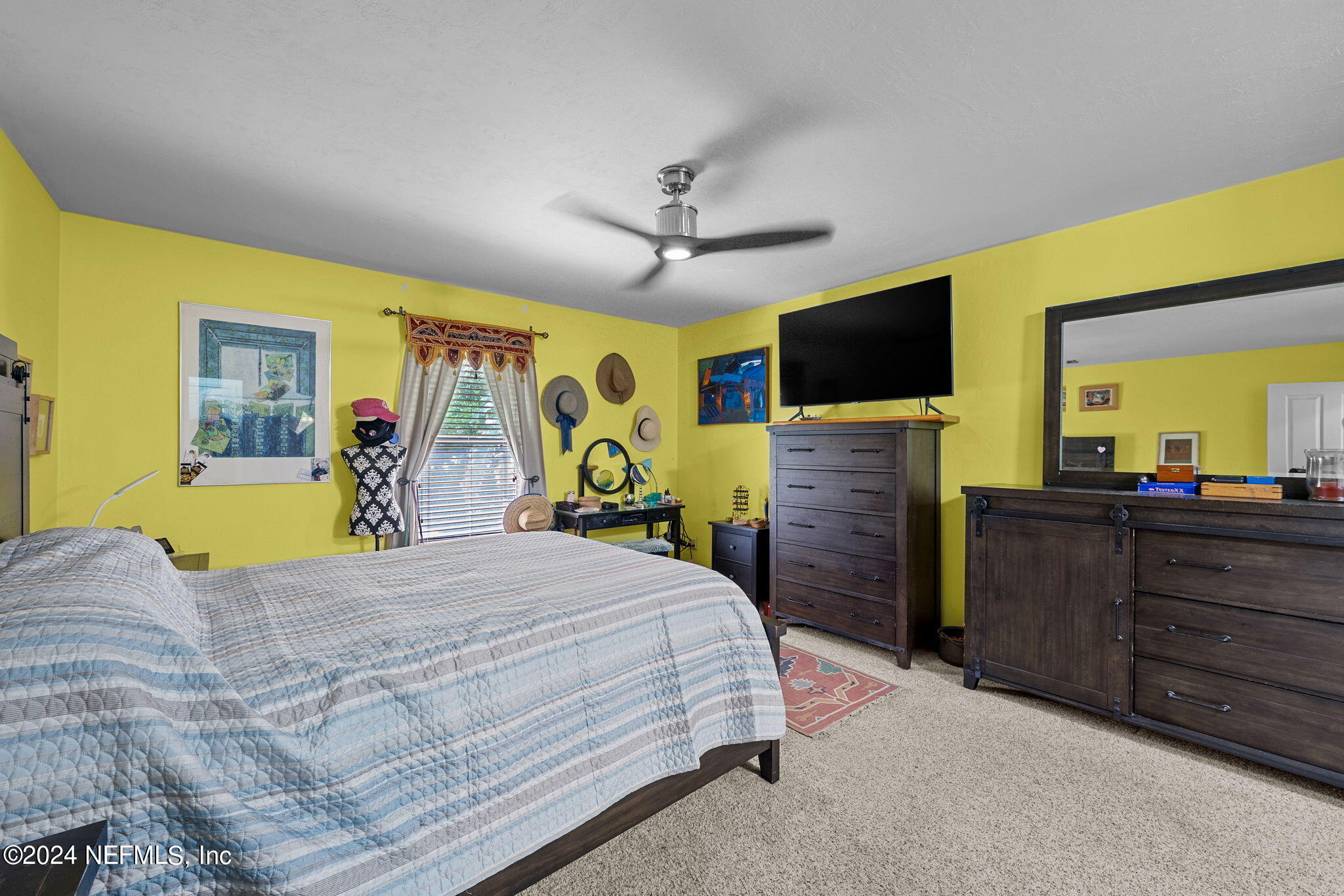 529 Fox Hollow Lane St. Augustine, FL 32086 - Photo 9 of 18 a bedroom with a bed and a flat screen tv