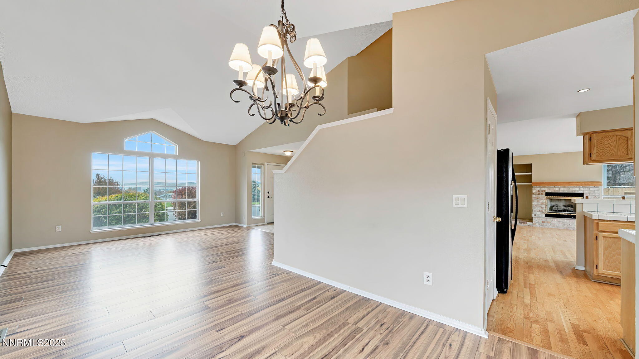 4690 Windcrest Drive Reno, NV 89523 - Photo 13 of 46 a view of a livingroom with a chandelier wooden floor and a kitchen
