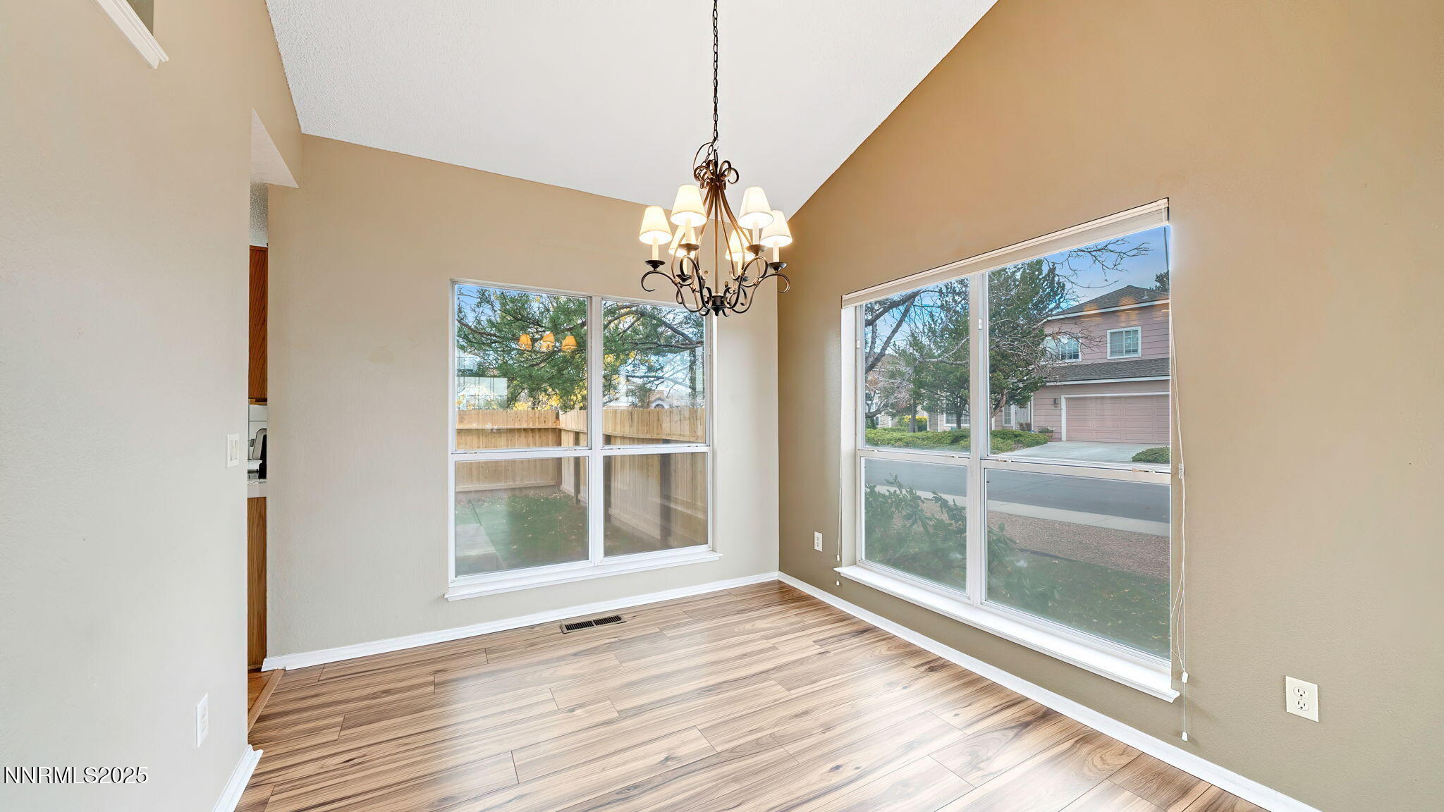 4690 Windcrest Drive Reno, NV 89523 - Photo 14 of 46 a view of a room with wooden floor large windows and chandelier