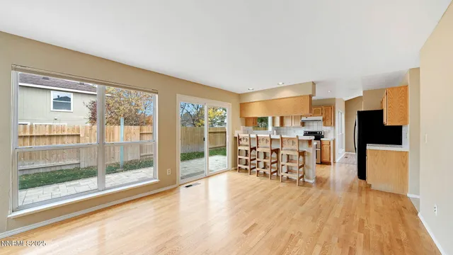 a dining room with furniture and a flat screen tv