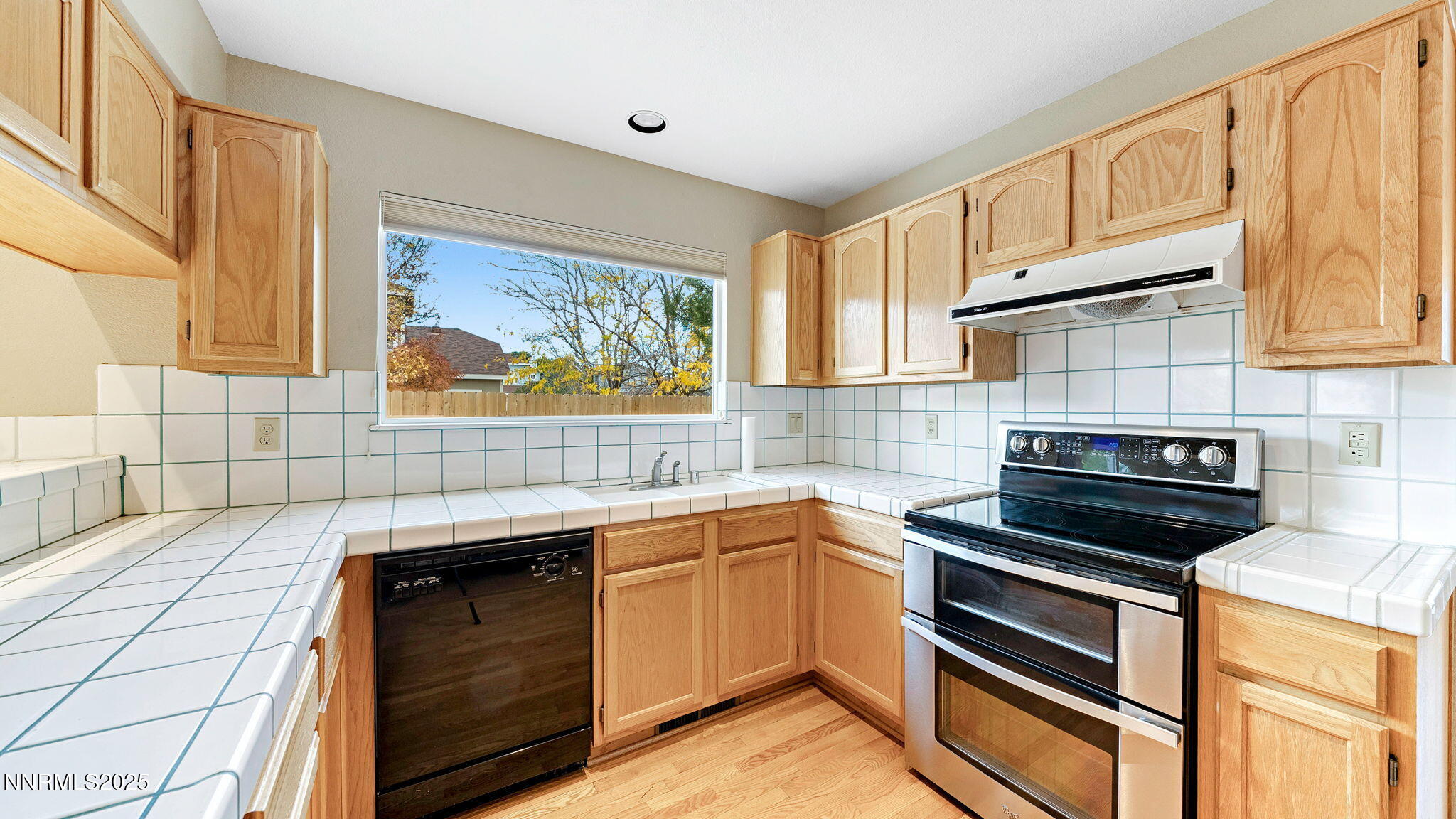 4690 Windcrest Drive Reno, NV 89523 - Photo 18 of 46 a kitchen with a sink stove and cabinets