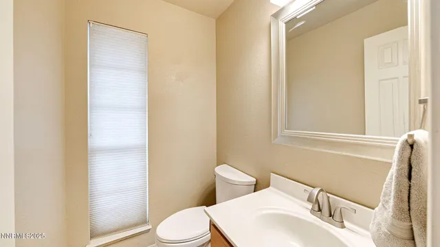 a white toilet sitting next to a bathroom sink