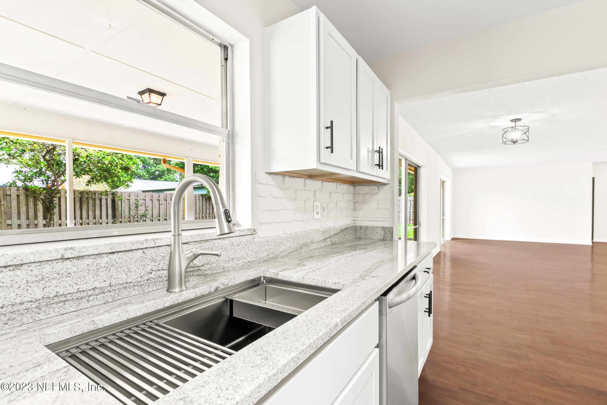 968 Espinado Avenue St. Augustine, FL 32086 - Photo 11 of 41 a kitchen with stainless steel appliances granite countertop a sink and a stove