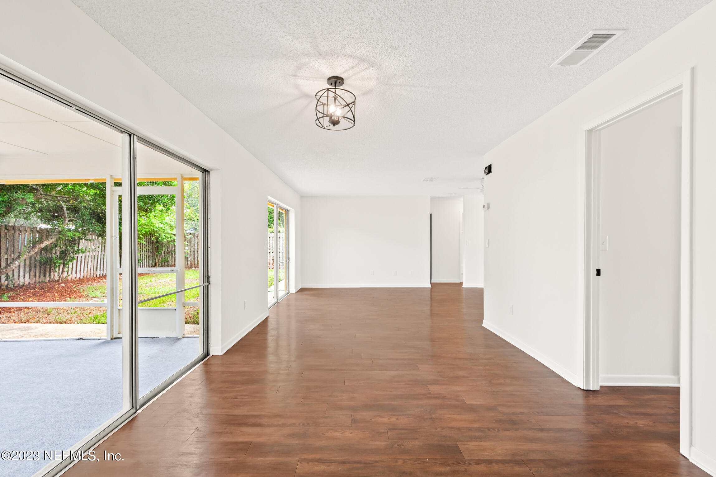 968 Espinado Avenue St. Augustine, FL 32086 - Photo 13 of 41 a view of an empty room with wooden floor and a window