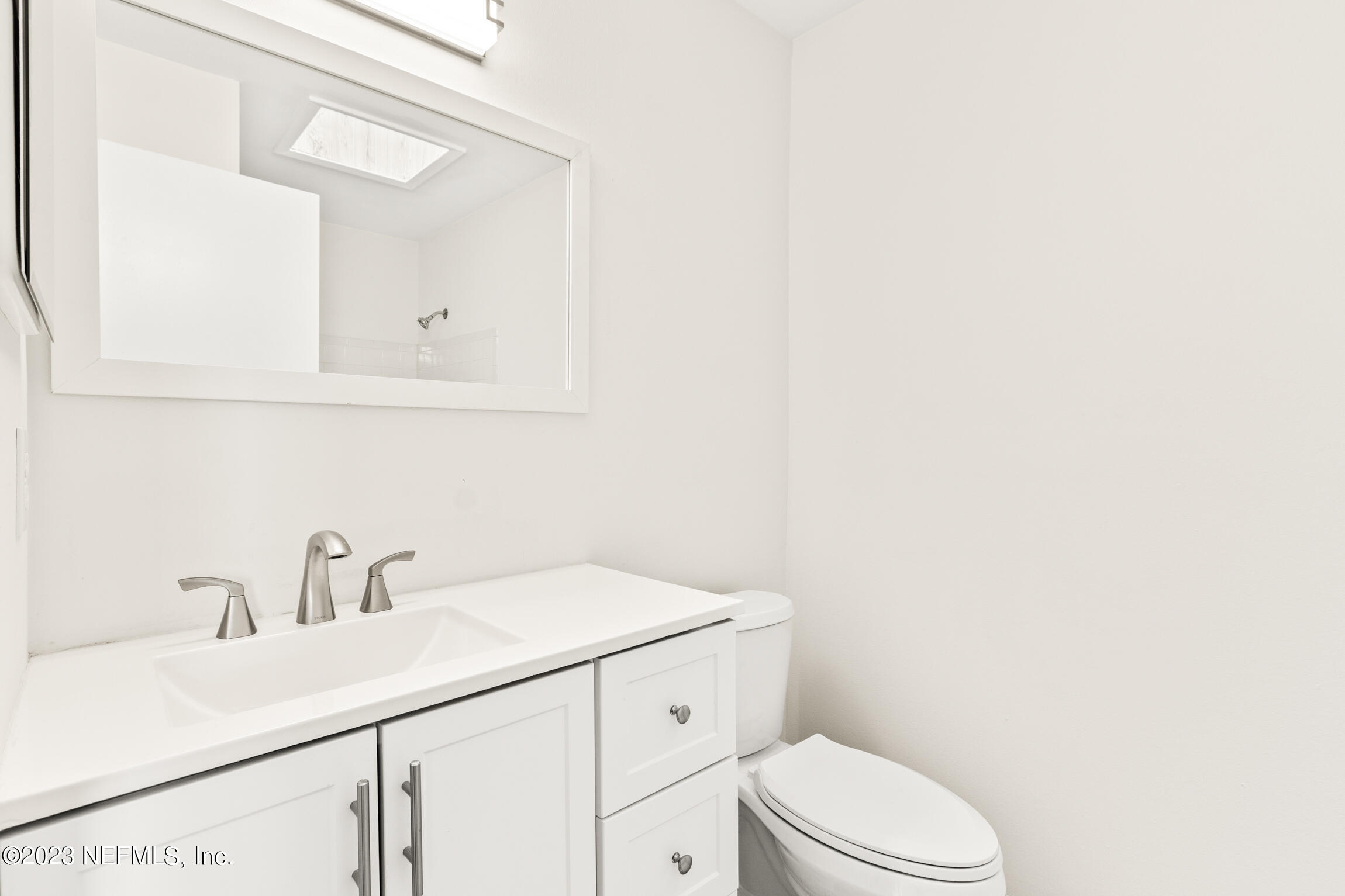 968 Espinado Avenue St. Augustine, FL 32086 - Photo 21 of 41 a bathroom with a sink a toilet and vanity