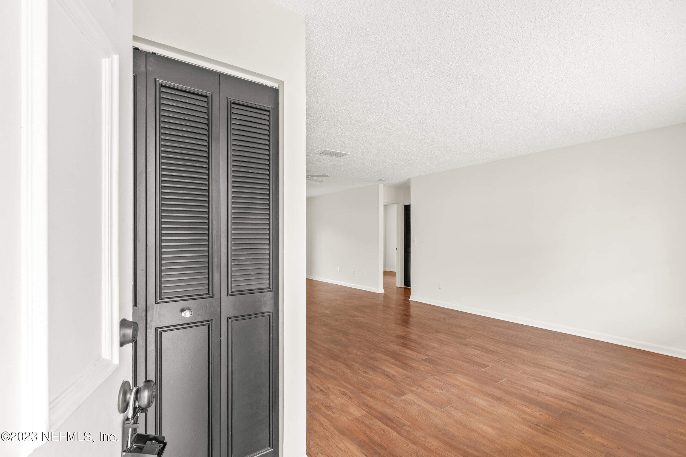 968 Espinado Avenue St. Augustine, FL 32086 - Photo 6 of 41 a view of an empty room with wooden floor and a window