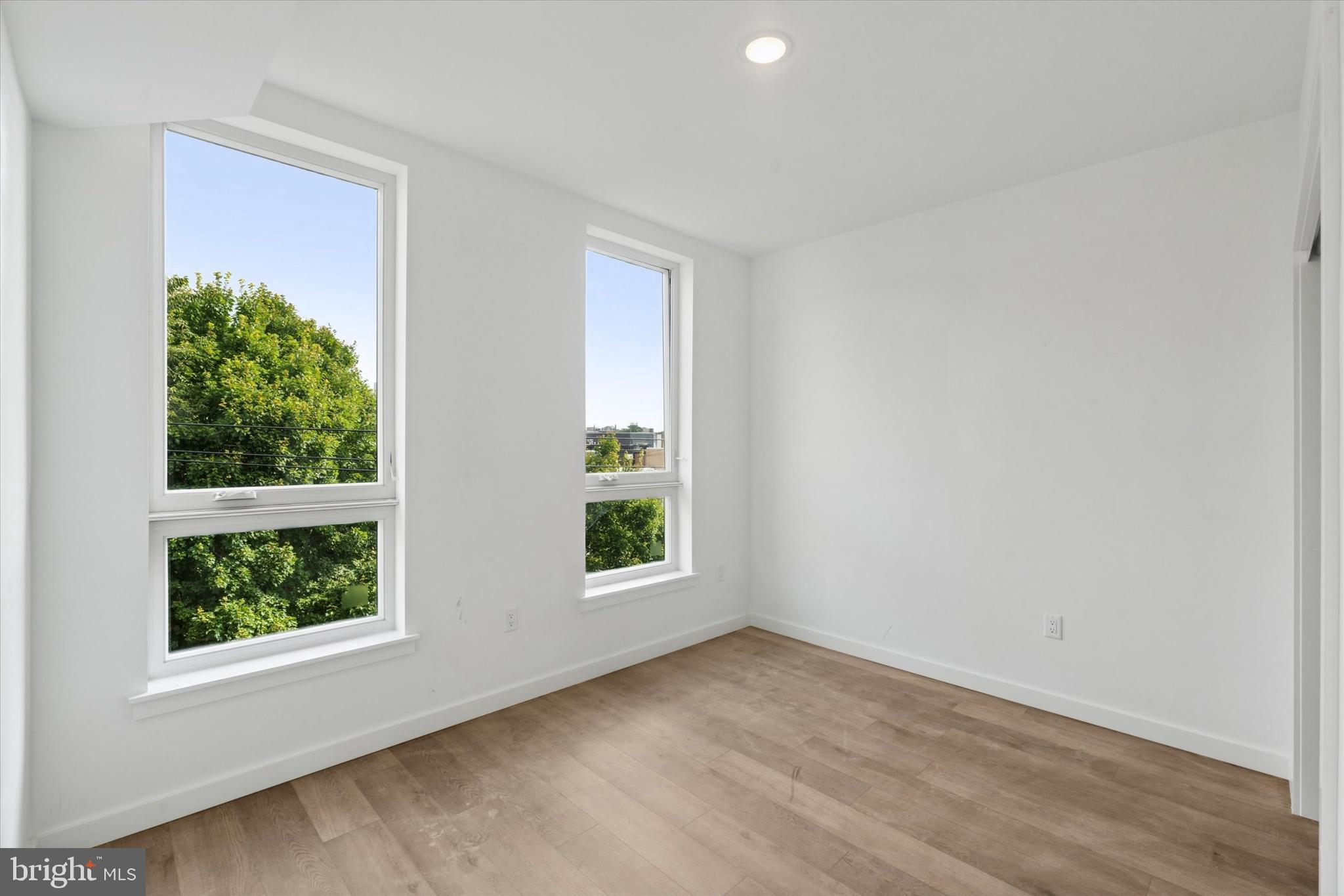 754 South 4th Street, Unit 203 Philadelphia, PA 19147 - Photo 7 of 18 an empty room with wooden floor and windows