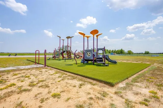 a view of a park with swings and slides