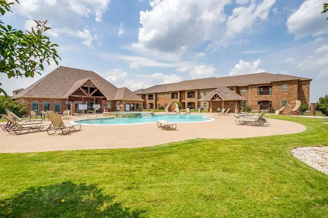 a view of house with outdoor space and swimming pool