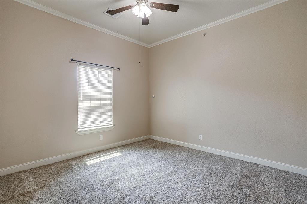 301 County Road 207, Unit 1110 Alvarado, TX 76009 - Photo 9 of 25 an empty room with a chandelier fan and windows