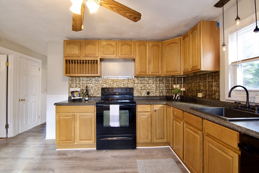 25 Chudy Street Three Rivers, MA 01080 - Photo 16 of 42 a kitchen with stainless steel appliances granite countertop a sink and a stove