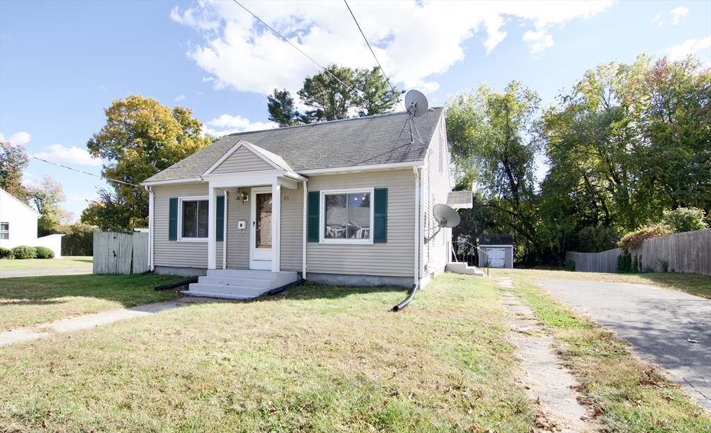25 Chudy Street Three Rivers, MA 01080 - Photo 2 of 42 a front view of a house with a yard and garage