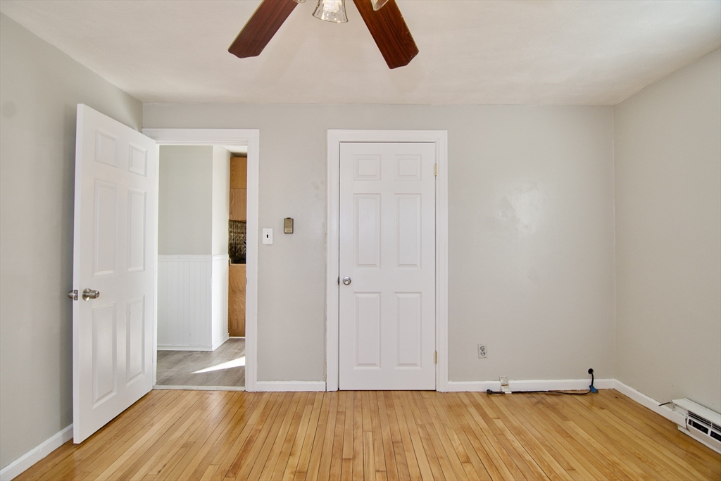 25 Chudy Street Three Rivers, MA 01080 - Photo 23 of 42 an empty room with wooden floor and windows