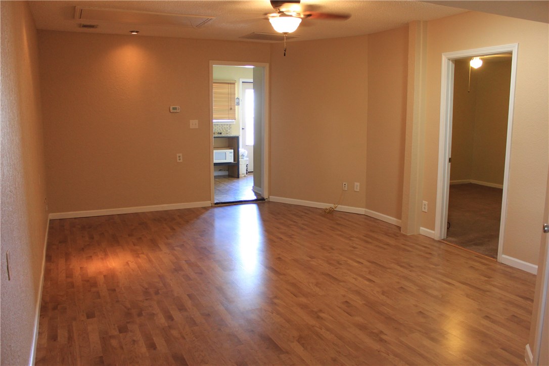6 Fairview Drive Round Rock, TX 78665 - Photo 5 of 12 a view of an empty room with wooden floor and a window