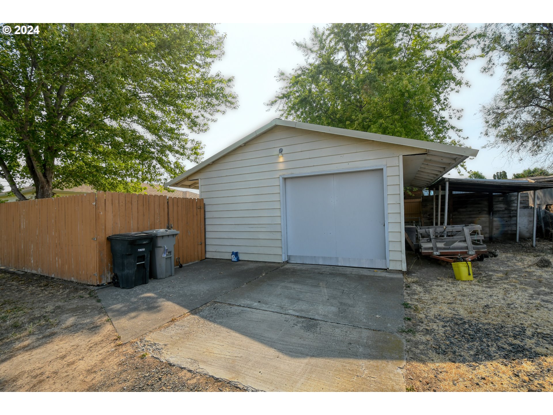 611 Southwest Birch Street Pilot Rock, OR 97868 - Photo 24 of 26 a backyard of a house with wooden fence and a tree