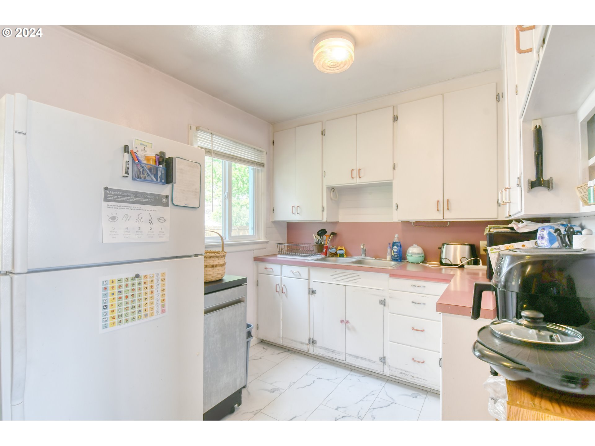 611 Southwest Birch Street Pilot Rock, OR 97868 - Photo 8 of 26 a kitchen with stainless steel appliances a stove a sink cabinets and a window