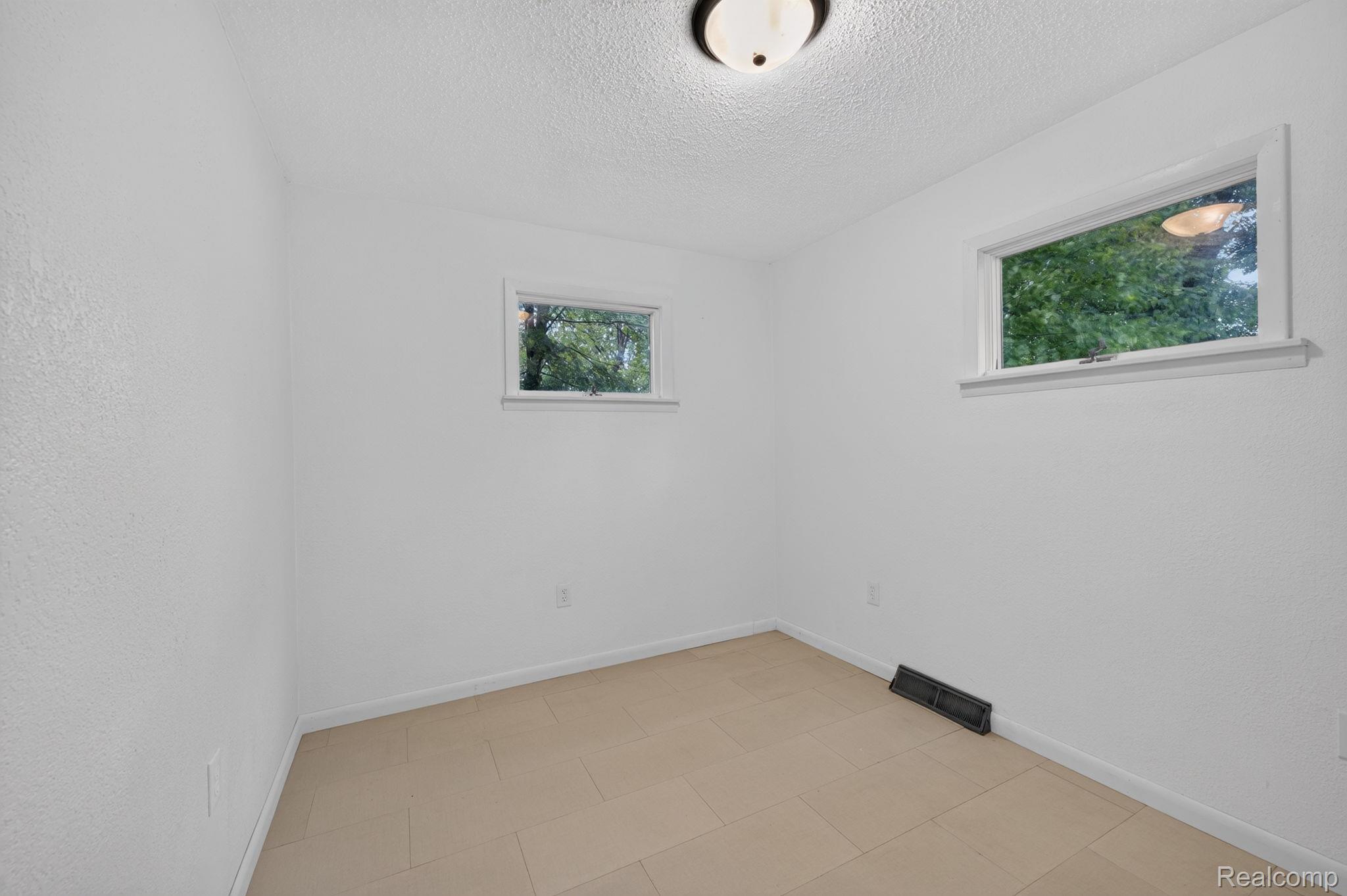9288 Hilda Lane Flushing, MI 48433 - Photo 34 of 50 Room featuring light-toned flooring, white walls, and a ceiling-mounted light fixture