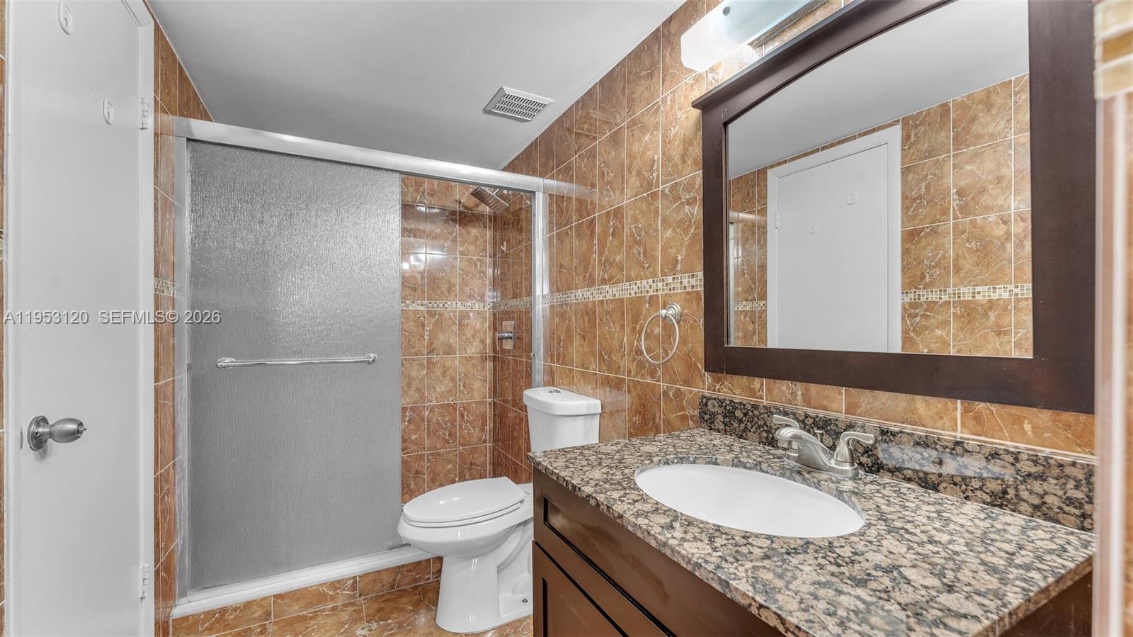 2780 West 76th Street, Unit 203 Hialeah, FL 33016 - Photo 15 of 21 a bathroom with a granite countertop sink toilet and shower
